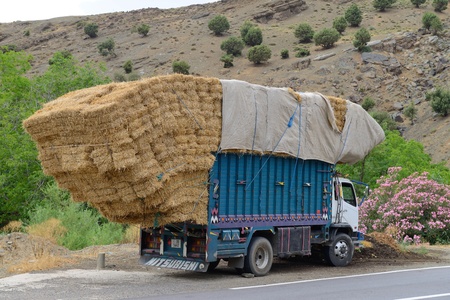 ATLAS, MOROCCO - JULY 10: Overloaded truck staying on road, July 10, 2013 in Atlas Mountains, Morocco. Road in Atlas Mountains very popular tourist route in central Morocco.のeditorial素材