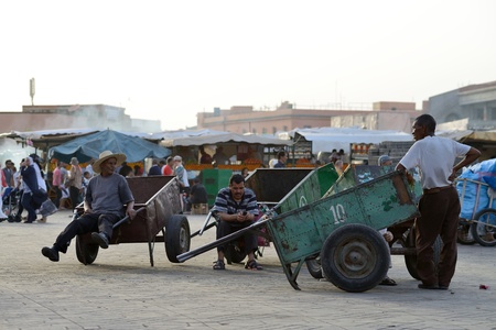MARRAKESH - JULY 09: Unidentified people stay in her trolleys in the Jemaa el Fna Square at sunset, July 09, 2013 in a Marrakesh, Morocco. The square is part of the UNESCO World Heritage.のeditorial素材