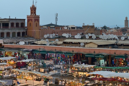 MARRAKESH - JULY 09: Unidentified people visit the Jemaa el Fna Square at sunset, July 09, 2013 in a Marrakesh, Morocco. The square is part of the UNESCO World Heritage.のeditorial素材