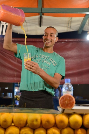 MARRAKESH - JULY 10: Unidentified people sells orange juice in Jemaa el Fna Square at sunset, July 10, 2013 in a Marrakesh, Morocco. The square is part of the UNESCO World Heritageのeditorial素材