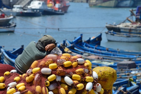 ESSAOUIRA - JULY 15  Unknown man sleep on the net in harbor of Essaouira, Morocco, July 15, 2013  Essaouira is one of the most popular tourist place on Atlantic coast in Morocco  のeditorial素材
