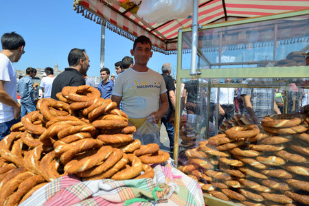 ISTANBUL - AUGUST 8  Unknown man trades traditional turkish food in a street near harbor, August 8,...