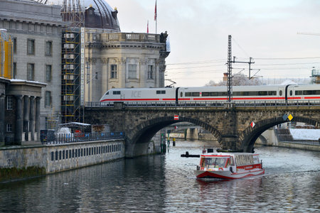 BERLIN - DECEMBER 26: Train on the bridge on 26 December 2013 in Berlin, Germany. Deutsche Bahn (state-owned private company) is the main provider of railway serviceのeditorial素材