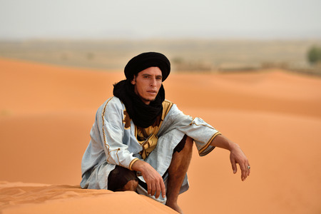 SAHARA, MOROCCO - AUGUST 03: Unidentified bedouin man wears traditional clothing in Sahara desert in Morocco, August 03, 2015. The Sahara is the largest hot desert.のeditorial素材