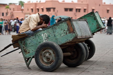 MARRAKESH - AUGUST 07: Unidentified man rest in a trolley in Jemaa el Fna Square at sunset, August 07, 2015 in a Marrakesh, Morocco. The square is part of the UNESCO World Heritageのeditorial素材