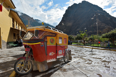 OLLANTAYTAMBO, PERU - September 04, 2016: Auto rickshaw on parking in Ollantaytambo, Peru on September 04, 2016. Ollantaytambo is a town and an Inca archaeological site in southern Peru.のeditorial素材