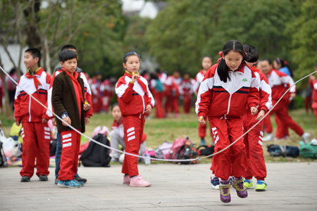 SUZHOU, CHINA - MARCH 22: Chinese school children play in park on March 22 2016 in Suzhou China. Suzhou is a major economic center and focal point of trade and commerce in Jiangsu Province China.のeditorial素材