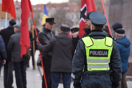 VILNIUS LITHUANIA - MAR 11: Police officers on duty in a nationalist rally at Gedimino Avenue on Re-Establishment of Independence Day on March 11 2017 in Vilnius Lithuaniaのeditorial素材