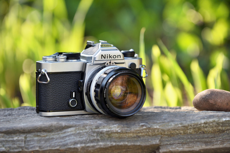 VILNIUS - MAY 8: Nikon vintage film camera with Nikkor 35mm lens on May 8, 2017 in Vilnius, Lithuania. Nikon Corporation specializing in optics and imaging products.のeditorial素材
