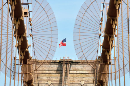 American flag on Brooklyn Bridge, with blue sky, New York CIty