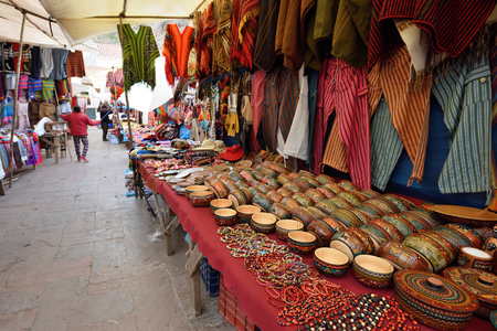 PISAC, PERU - September 04, 2016: Colourful goods for sale in marketplace in Pisac, Peru on September 04, 2016. Pisac is a town and an Inca archaeological site in Peru.のeditorial素材