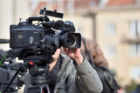 Vilnius, Lithuania - April 15, 2018: TV camera man filming a political event in Vilnius on April 15, 2018. Vilnius is the capital of Lithuania and its largest cityのeditorial素材