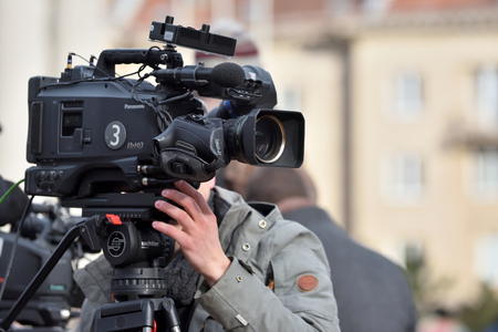 Vilnius, Lithuania - April 15, 2018: TV camera man filming a political event in Vilnius on April 15, 2018. Vilnius is the capital of Lithuania and its largest cityのeditorial素材