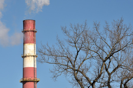 Smoke from the chimney of the industrial plant. Industrial, ecology and environmental protection.の写真素材