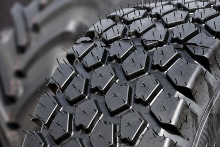 Big truck or tractor wheel a black tires closeup