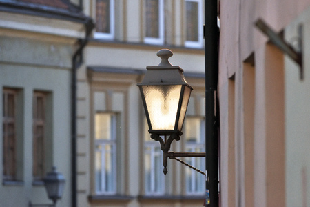 Street lamp on the wall in Old Town of Vilniusの写真素材