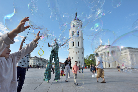 Vilnius, Lithuania, May 4: Unknown street artist makes big soap bubbles in a public square on May 4, 2018 in Vilnius, Lithuania. Vilnius is the capital of Lithuania and its largest city.のeditorial素材