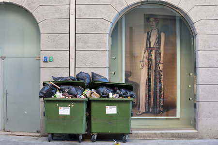 Vilnius, Lithuania - May 19: Green containers with garbage in Vilnius Old Town on May 19, 2018 in...