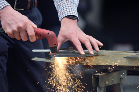 Laser cutting of flat sheet metal steel material with sparks