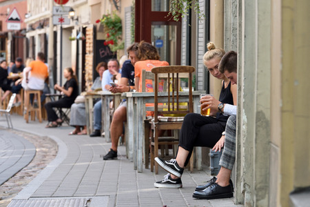 Vilnius, Lithuania - August 18: Unidentified people in Vilnius Old Town street cafe on August 18, 2018 in Vilnius Lithuania. Vilnius is the capital of Lithuania and its largest city.のeditorial素材