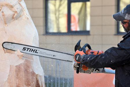 Kaunas, Lithuania - April 04: Unidentified man cutting wood with Stihl chainsaw in Kaunas on April 04, 2019. Stihl is a German manufacturer of chainsaws and other handheld power equipmentのeditorial素材