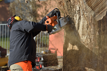 Kaunas, Lithuania - April 04: Unidentified man cutting wood with Stihl chainsaw in Kaunas on April 04, 2019. Stihl is a German manufacturer of chainsaws and other handheld power equipmentのeditorial素材