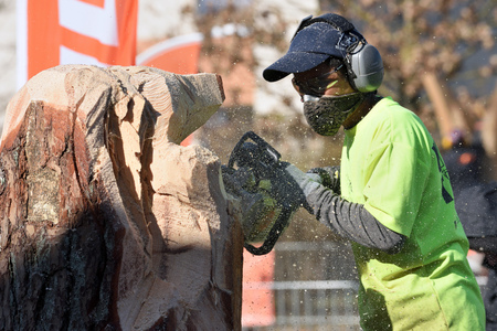 Kaunas, Lithuania - April 04: Unidentified man cutting wood with Stihl chainsaw in Kaunas on April 04, 2019. Stihl is a German manufacturer of chainsaws and other handheld power equipmentのeditorial素材