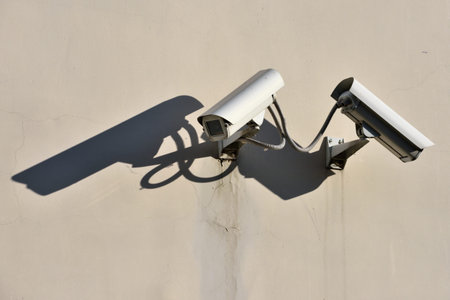 Modern CCTV security cameras on building wall outdoors