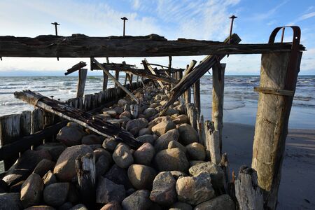 Old wood pier on the Baltic Sea at sunsetの写真素材