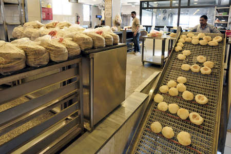 Madaba, Jordan - February 16, 2020. Unidentified people working at local bakery of Madaba, Jordan on February 16, 2020. Madaba is the capital city of Madaba Governorate in central Jordan.のeditorial素材