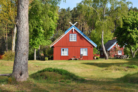 Traditional fishermans house in Preila, Lithuania. Preila is a resort town in Lithuania. Located on the Curonian Spit between the Curonian Lagoon and the Baltic Sea. Unesco Heritage.のeditorial素材