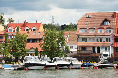 Mikolajki, Poland, July 12: Boats at harbor on July 12, 2020 at Mikolajki, Poland. Mikolajki is a resort town in the Warmian-Masurian Voivodeship in north-eastern Poland.のeditorial素材
