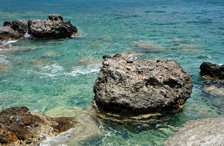 Clear blue waters at the coast on the south of Crete, Greece. A rocky waters edgeの写真素材