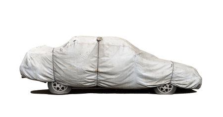 Car parked under gray cover, protection from rain and dust, on white backgroundの写真素材