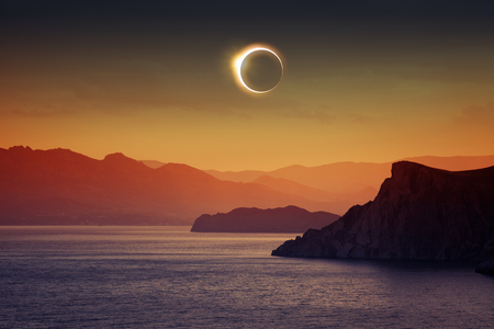 Scientific background, astronomical phenomenon - full sun eclipse, total solar eclipse, mountains and sea Scientific background, astronomical phenomenon - full sun eclipse, total solar eclipse, mountains and sea