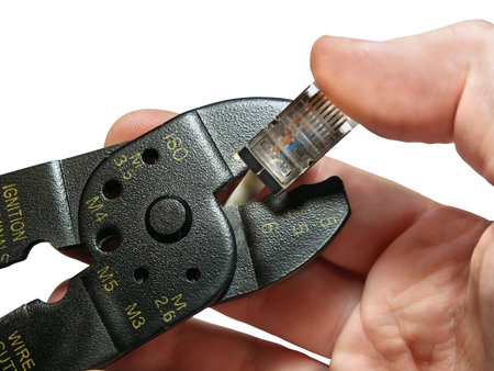 wire cutter and hand isolated on white background with pathの写真素材