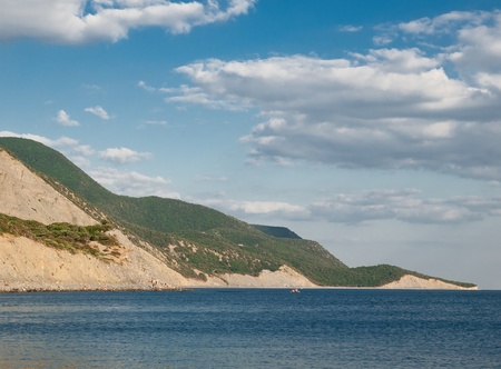 summer landscape with sea, rocks and blue sky with cloudsの写真素材
