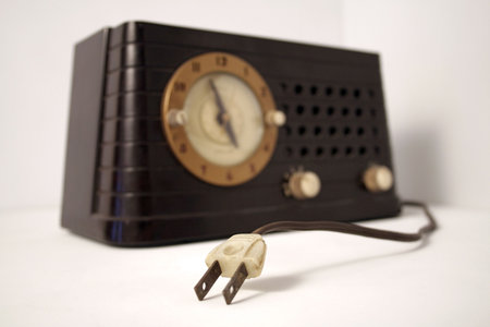 unplugged vintage clock radio set against a white backgroundの写真素材