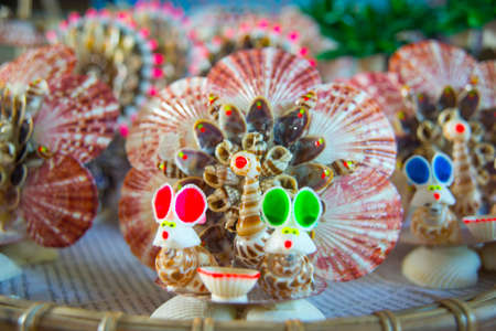 Different products made from collected sea shells, are sold on the shelves on the coast.の写真素材