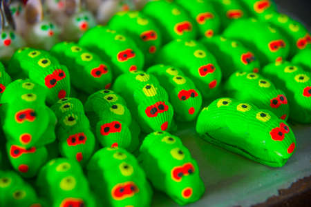 Lots of colorful, unusual and funny toys is on the tableの写真素材