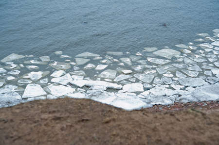 Huge ice floes in the river, the trees hanging over the water.Russia.の写真素材