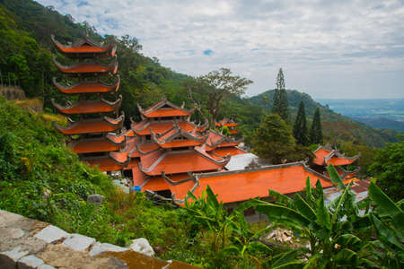 Asia. Vietnam.Phan Thiet. summer.Mountains in the distance and green leaves on the treesの写真素材