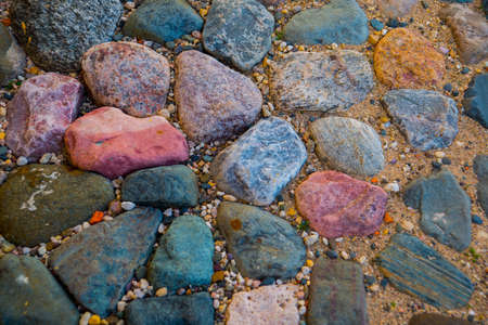 The old road is lined with small and large cobbleの写真素材