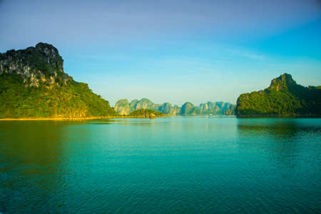 The beautiful rocky mountains reflected in the water.Sailing ships on the waterの写真素材