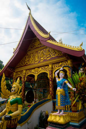 Gold decor, a beautiful temple with statues in the small town of Laos.の写真素材