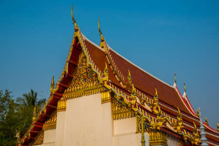Ancient Buddhist temples with gold in a small town in Thailand. Nakhon Ratchasima.の写真素材