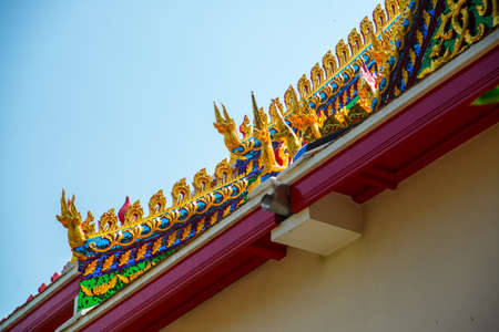 Beautiful religious building is white with gilding on a blue sky . Ayutthaya. Thailand.