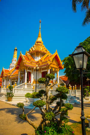 Beautiful religious building is white with gilding on a blue sky . Ayutthaya. Thailand.の写真素材