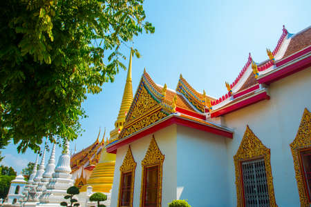 Beautiful religious building is white with gilding on a blue sky . Ayutthaya. Thailand.の写真素材