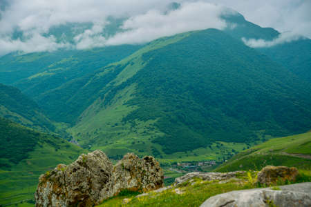Beautiful mountains in the clouds on the blue sky background,the summer.The Caucasus..Russia.の写真素材